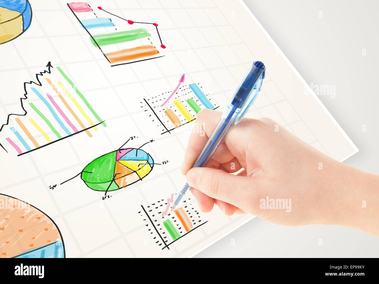 Business person drawing colorful graphs and icons on paper Stock Photo ...