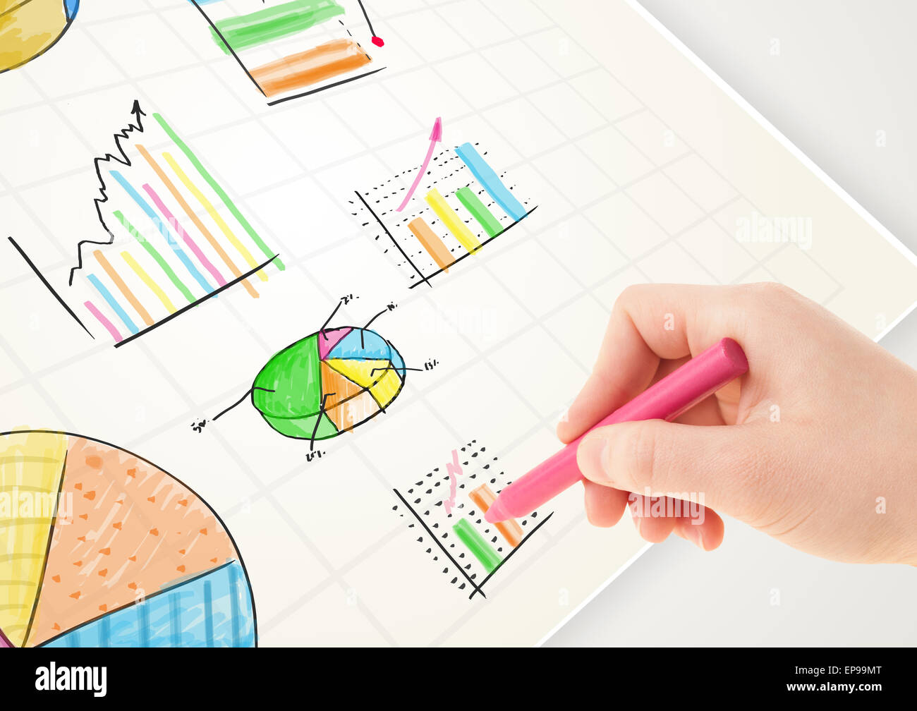 Business person drawing colorful graphs and icons on paper Stock Photo ...