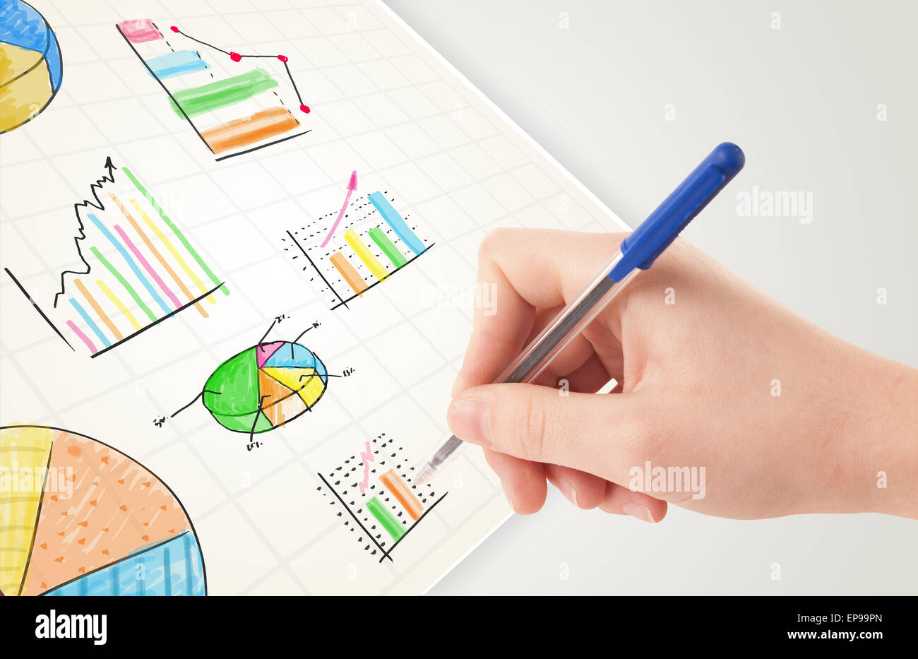 Business person drawing colorful graphs and icons on paper Stock Photo ...