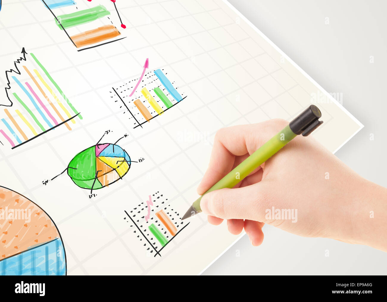 Business person drawing colorful graphs and icons on paper Stock Photo ...