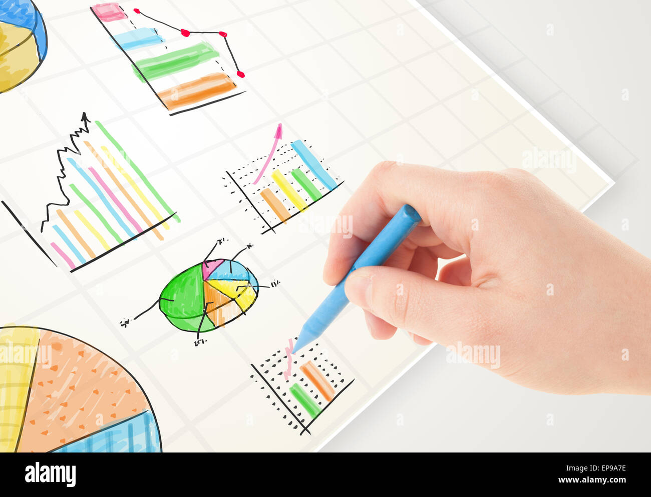 Business person drawing colorful graphs and icons on paper Stock Photo ...