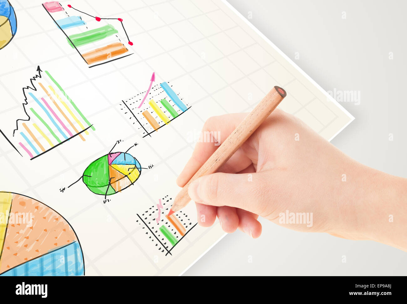 Business person drawing colorful graphs and icons on paper Stock Photo ...