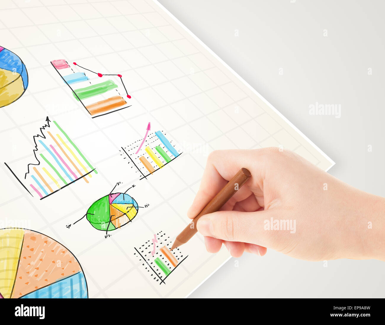 Business person drawing colorful graphs and icons on paper Stock Photo ...