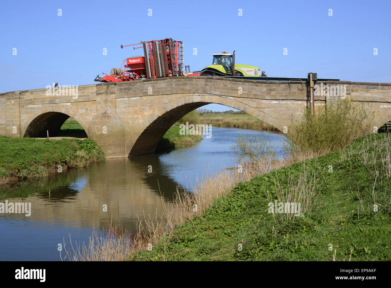 tractor crossing the river Derwent over grade II listed bridge Bubwith Yorkshire United Kingdom Stock Photo