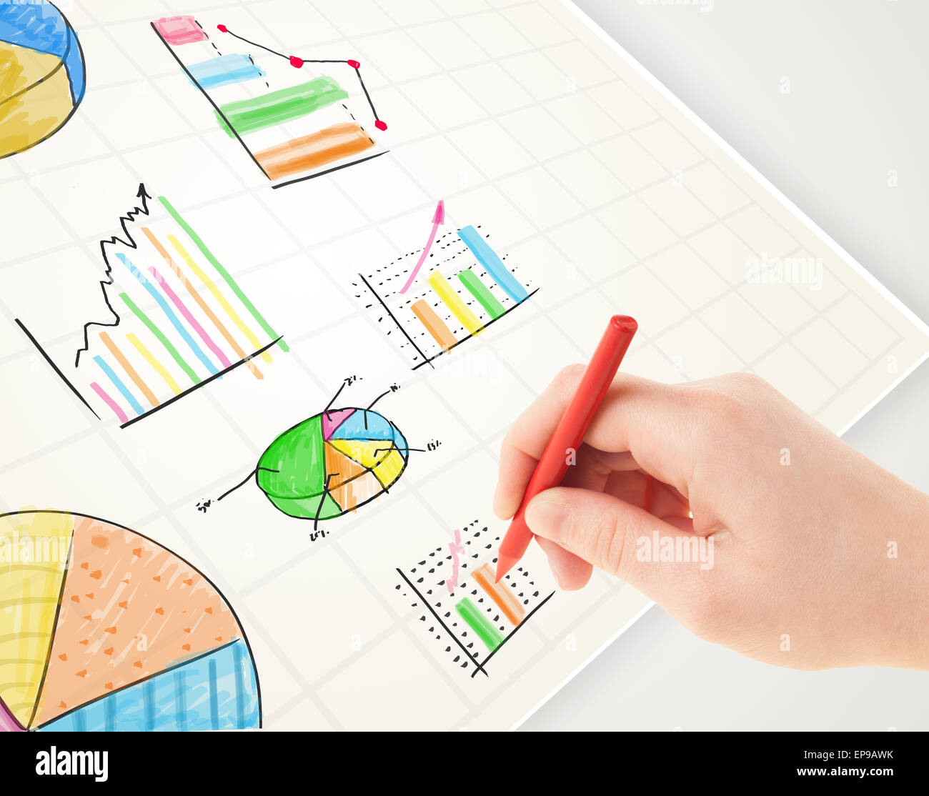 Business person drawing colorful graphs and icons on paper Stock Photo ...