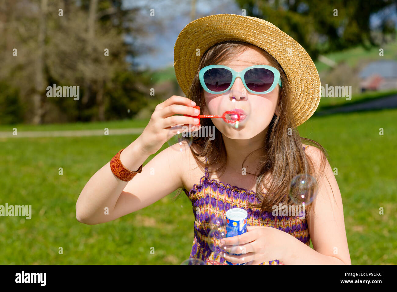 a little girl making soap bubbles in nature Stock Photo - Alamy