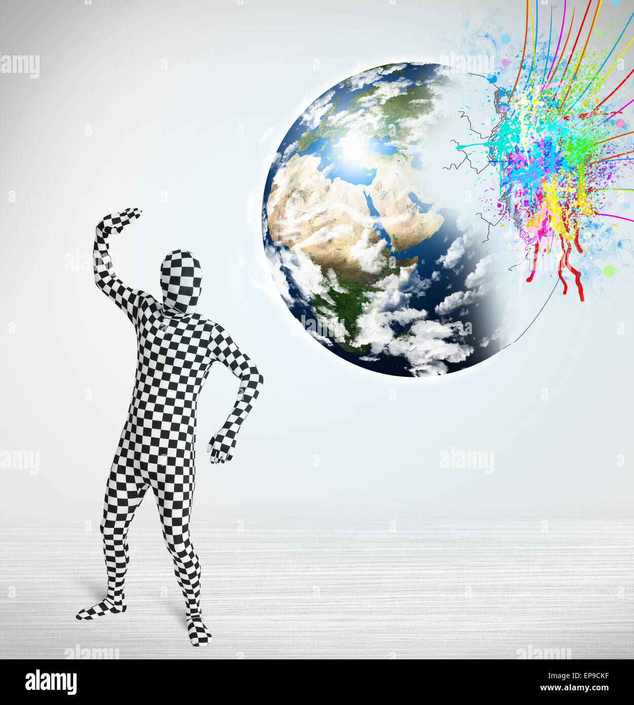 Funny man in body suit looking at colorful splatter earth Stock Photo