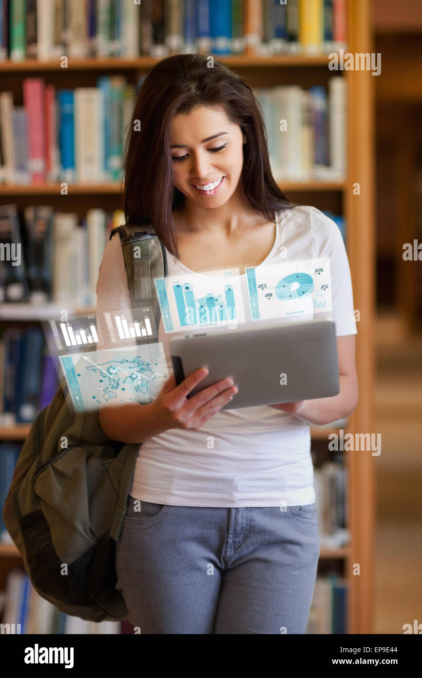 Happy pretty student working on her futuristic tablet Stock Photo