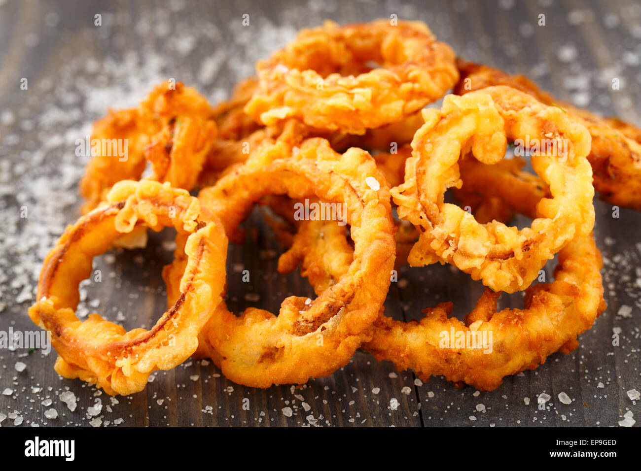 Homemade crunchy fried onion rings on a table Stock Photo