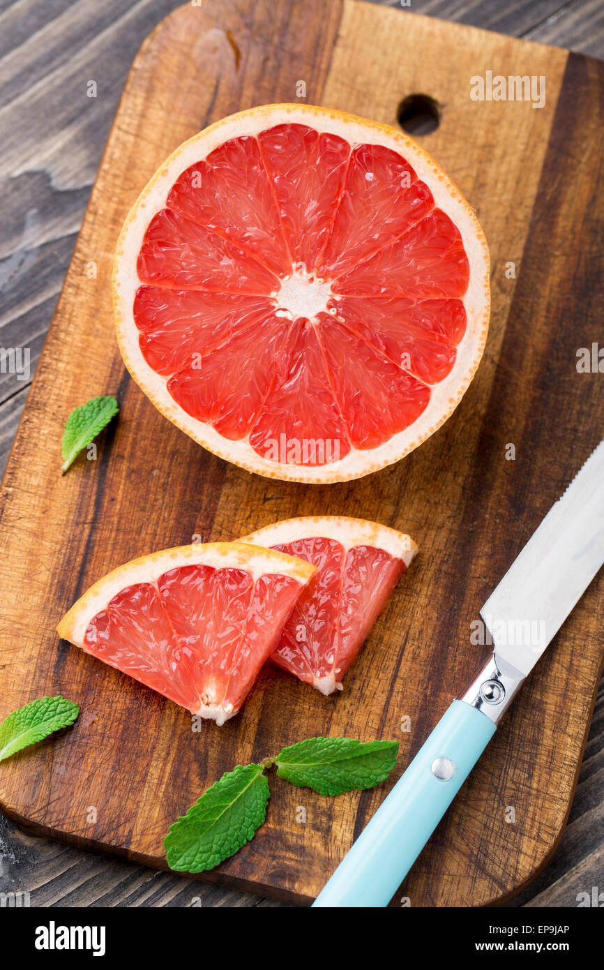 Grapefruit with slices on a wooden table. Stock Photo