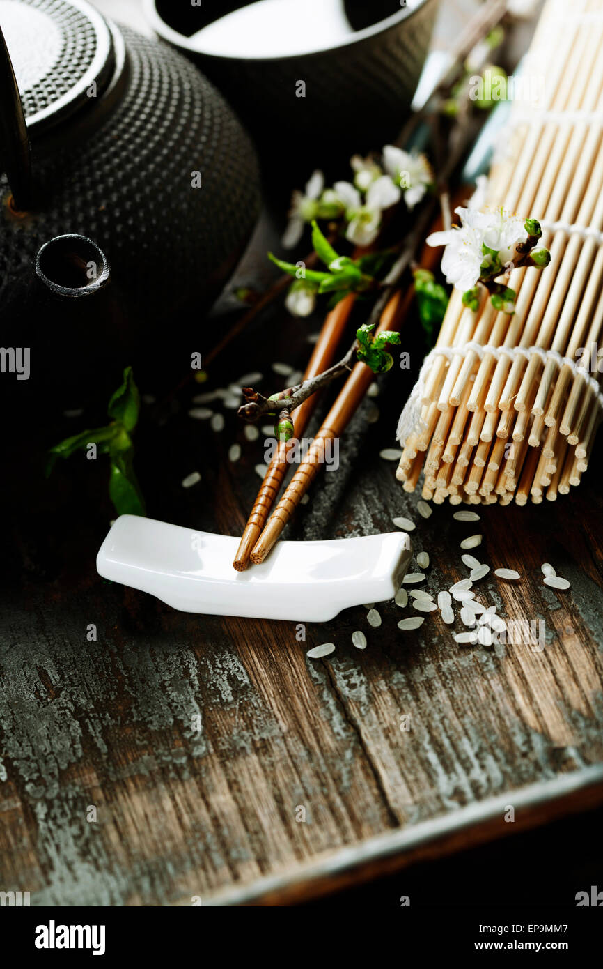 Chinese Tea Set,chopsticks and sakura branch on rustic wooden table Stock Photo