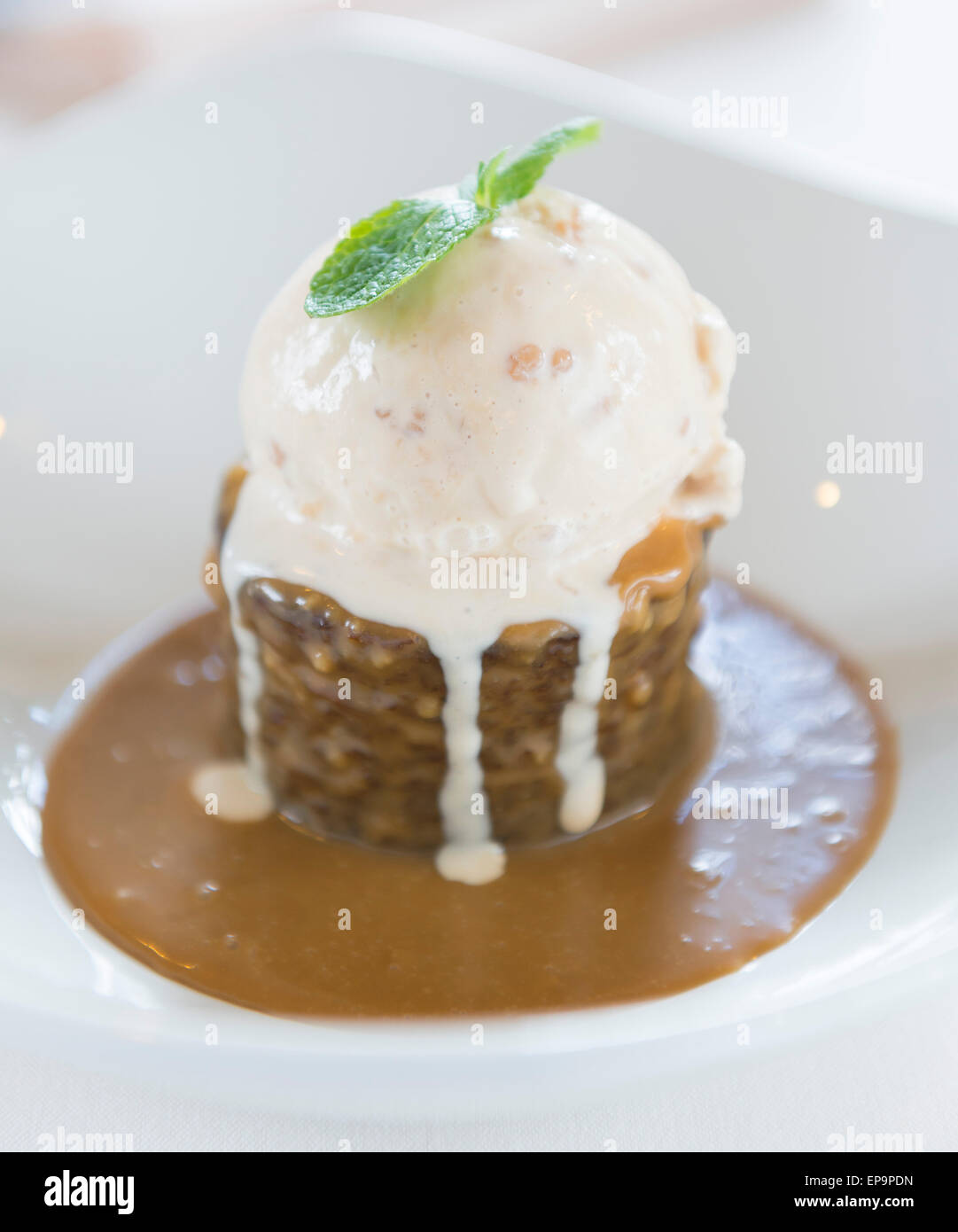 Sticky toffee pudding with ice cream with toffee sauce Stock