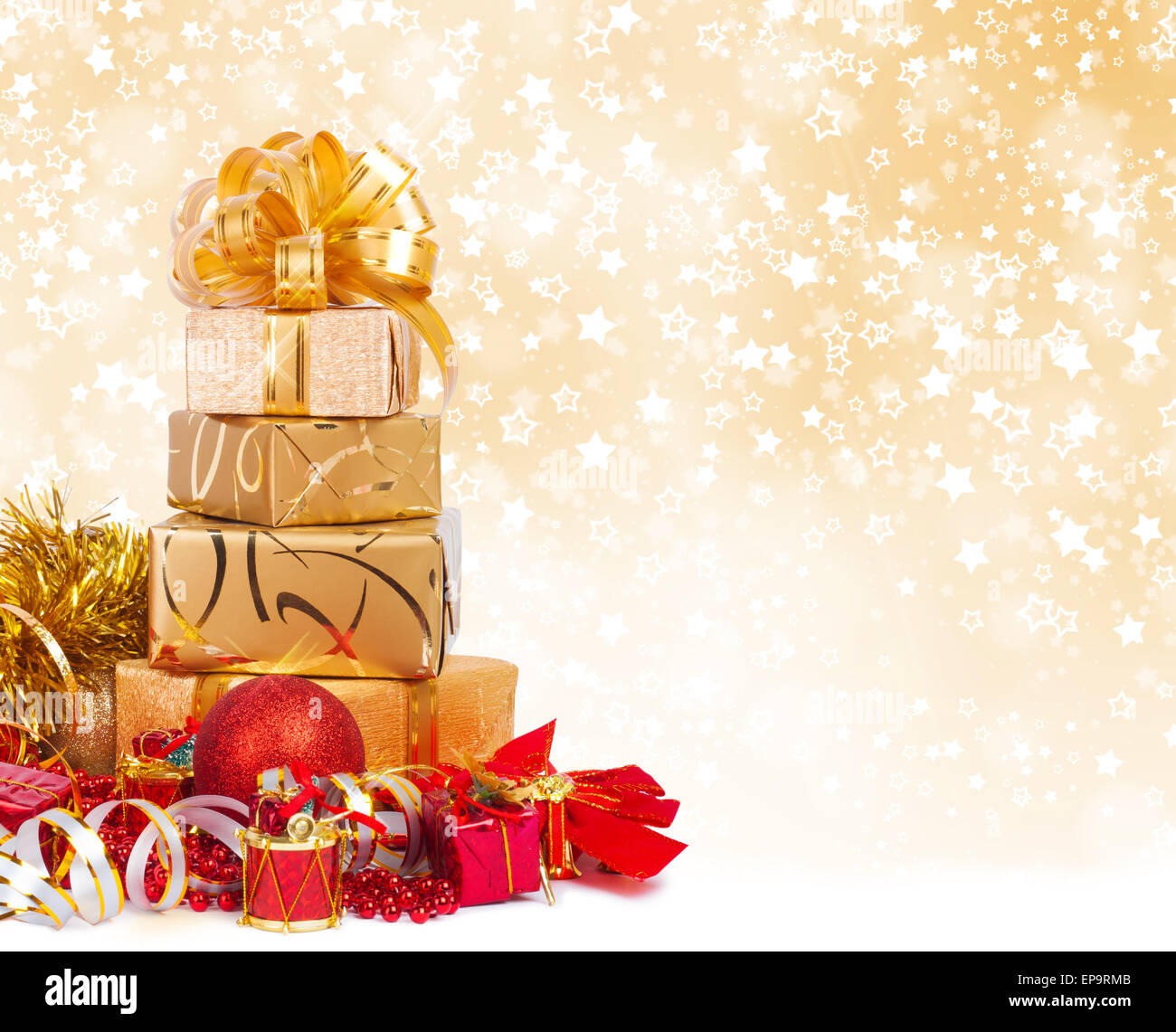 Gift box in gold wrapping paper on a beautiful abstract background Stock Photo