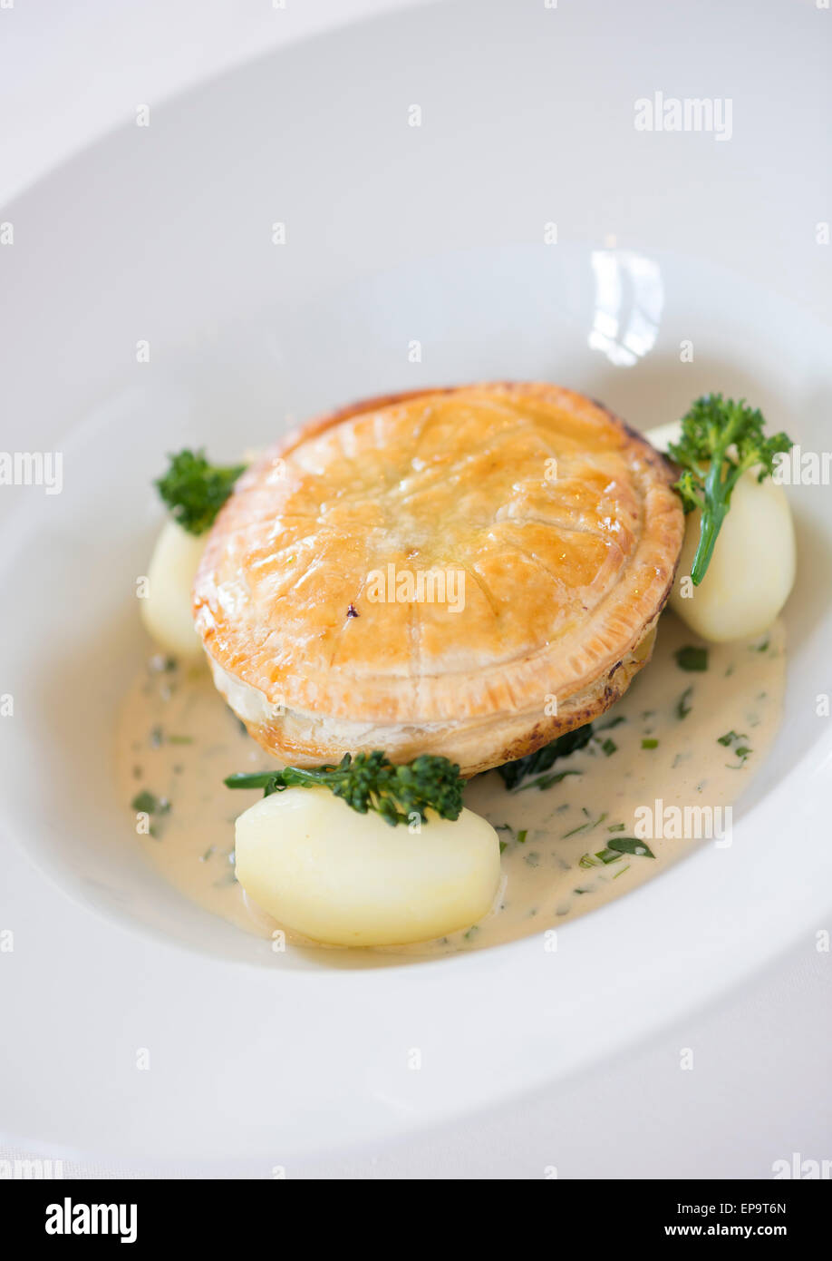 Wild Mushroom Pithivier with butttered spinach and tarragon cream sauce Stock Photo Alamy