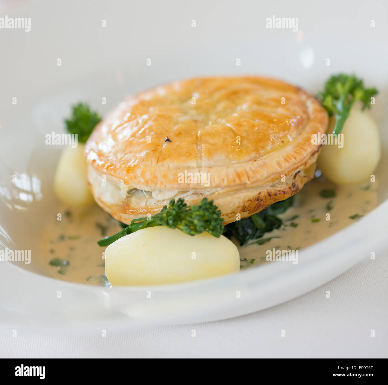 Wild Mushroom Pithivier with butttered spinach and tarragon cream sauce Stock Photo Alamy