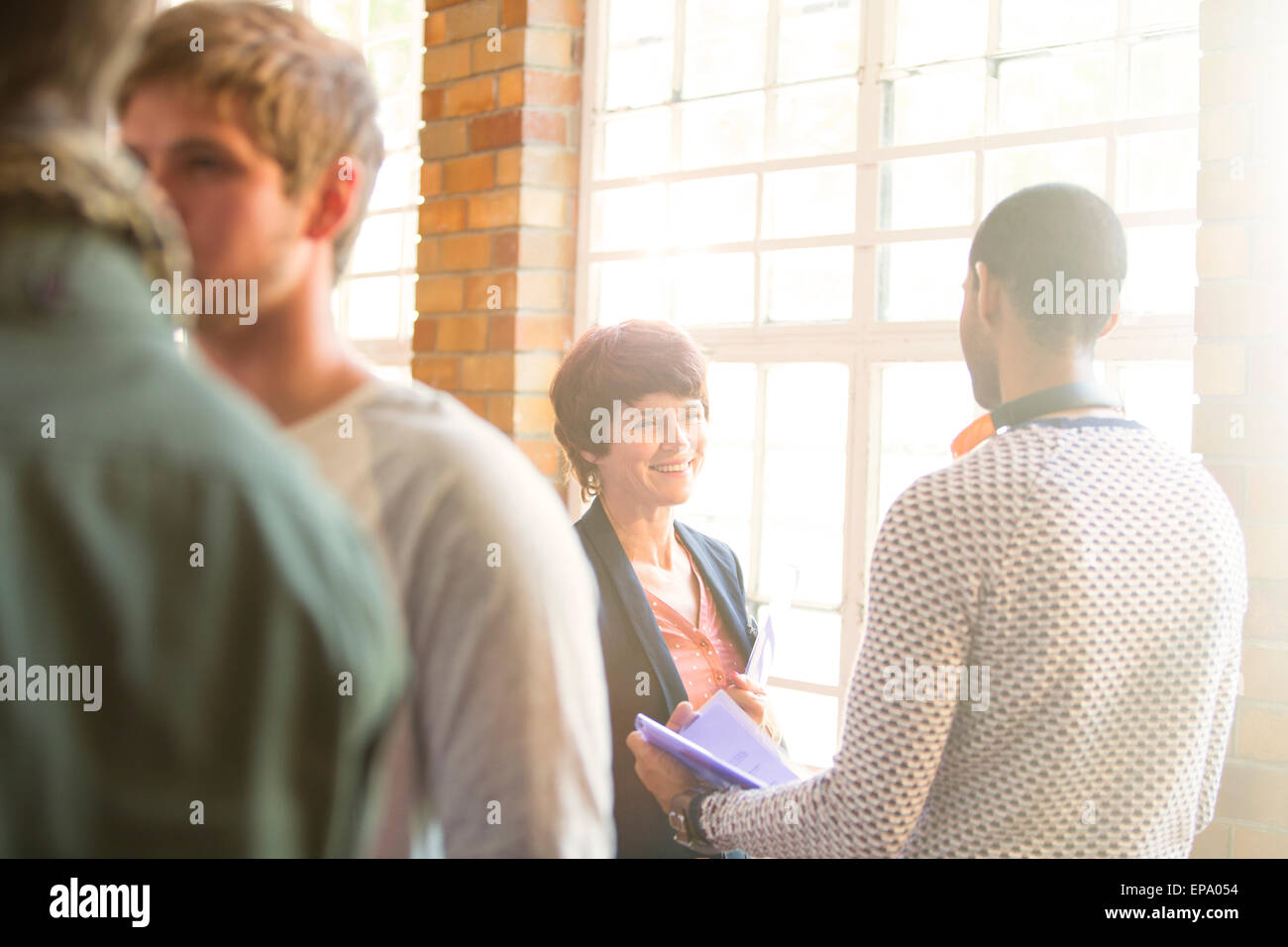 man woman talking window Community center Stock Photo