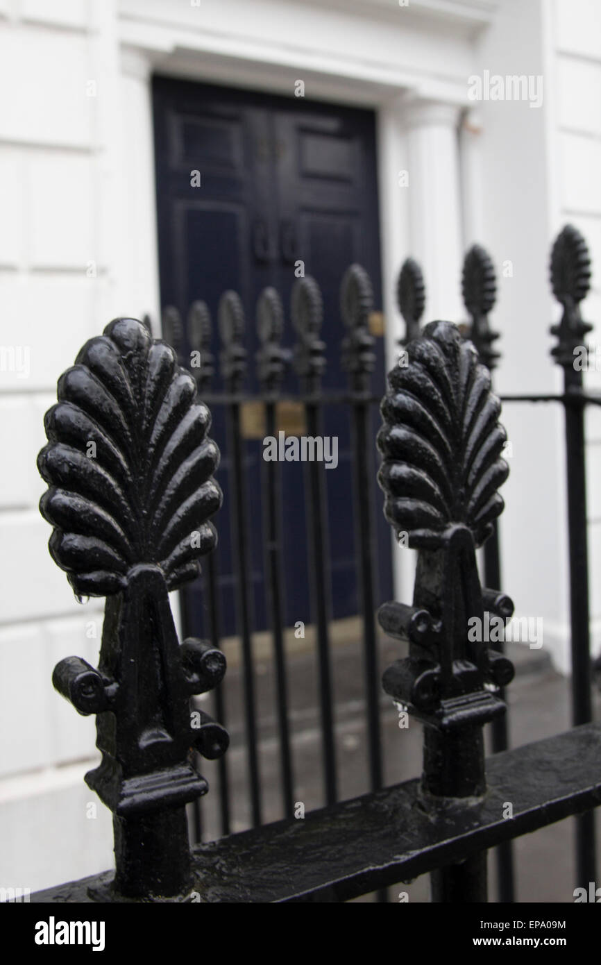 black iron railings in front of blue front door, London house Stock Photo