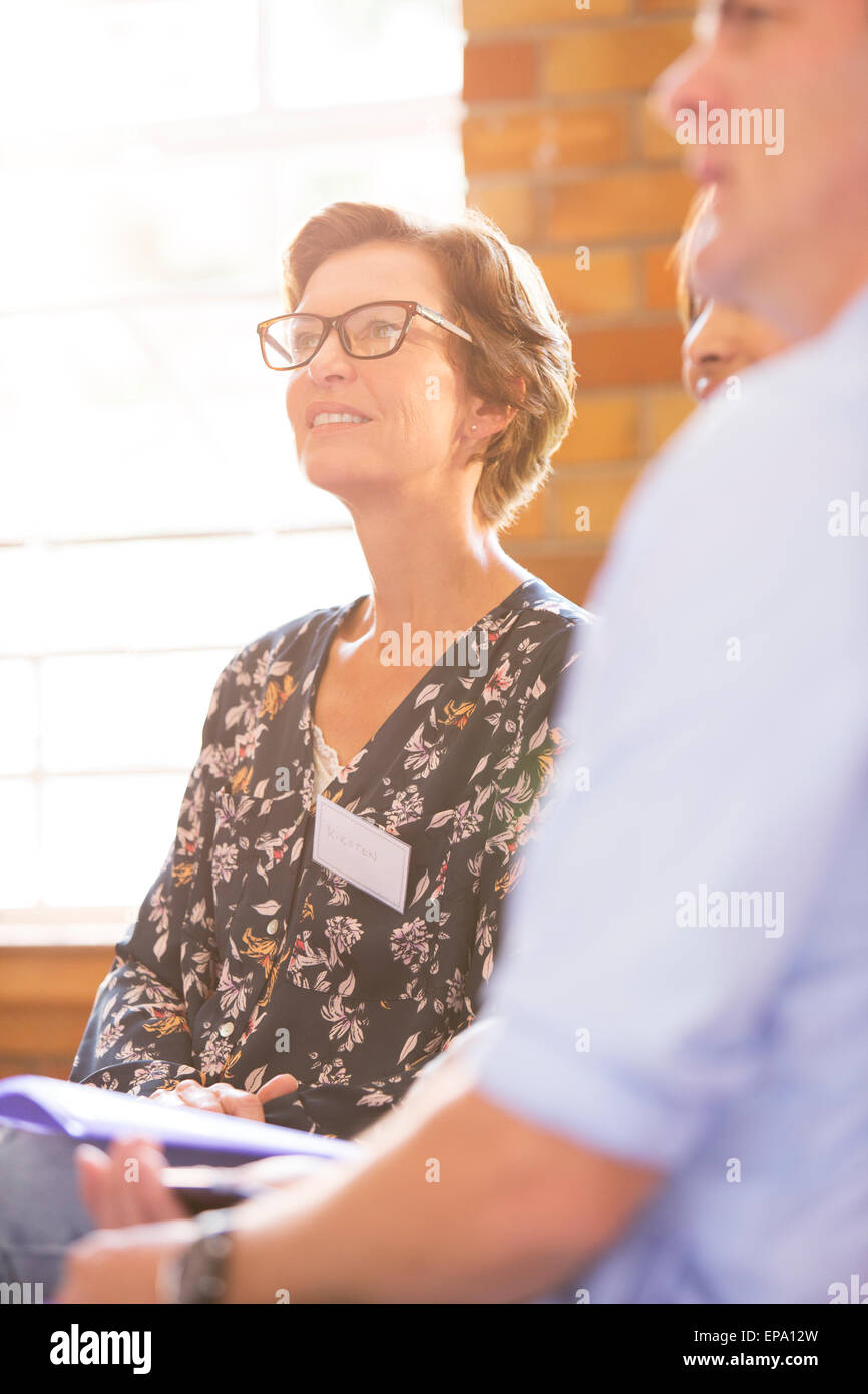 smiling woman listening meeting Stock Photo