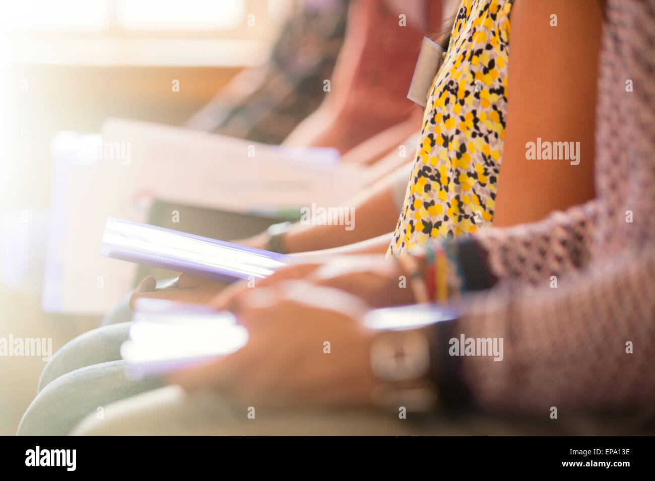 audience sitting in a row paperwork Stock Photo