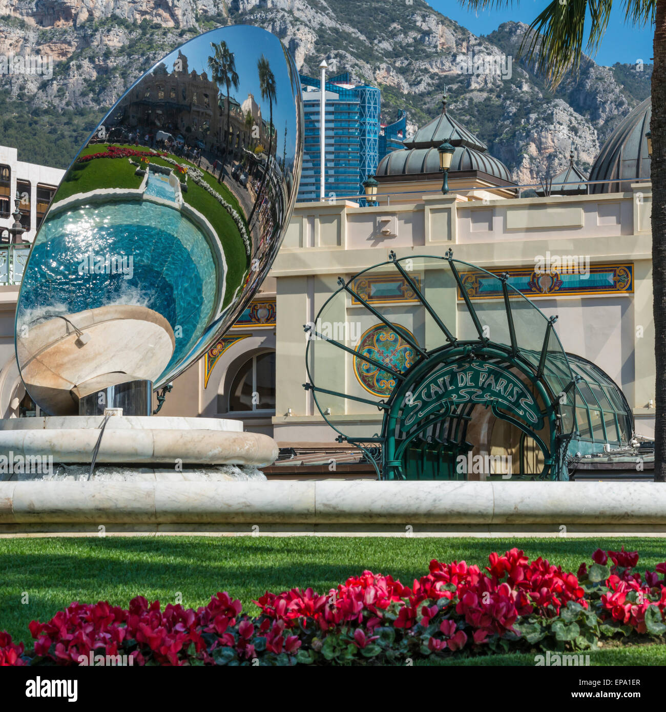 A reflection of the casino in a metal sculpture and the Cafe de Paris entrance in the background in Monte Carlo, Monaco Stock Photo