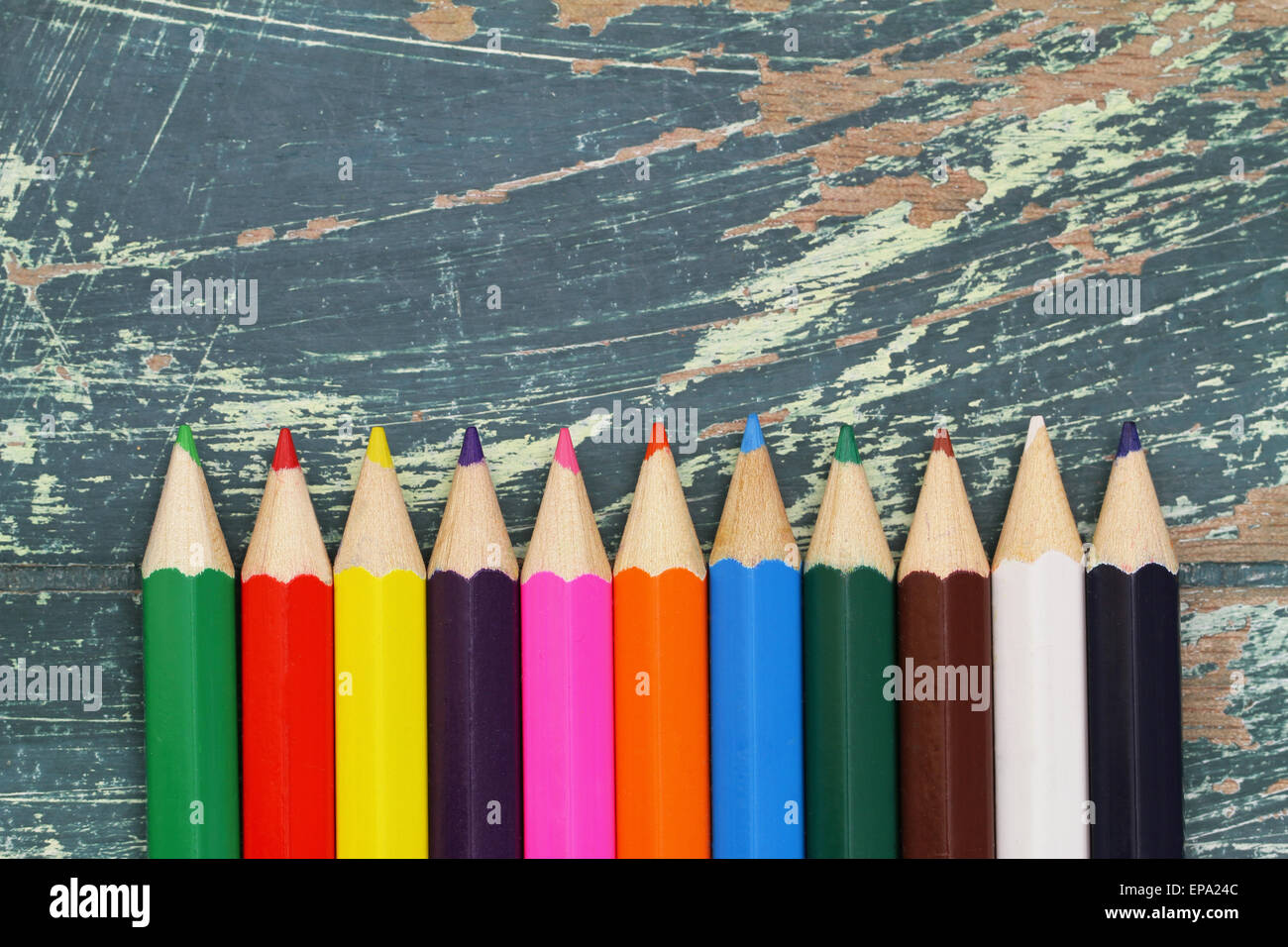 Colorful pencils on rustic wood with copy space Stock Photo - Alamy