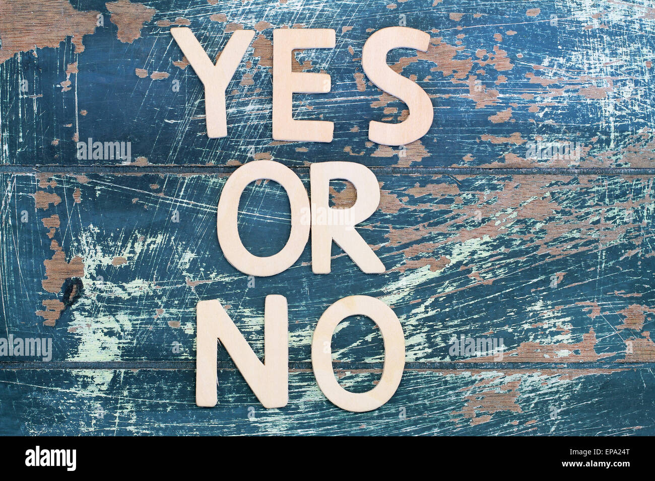 Yes or no written with wooden letters on rustic wooden surface Stock Photo