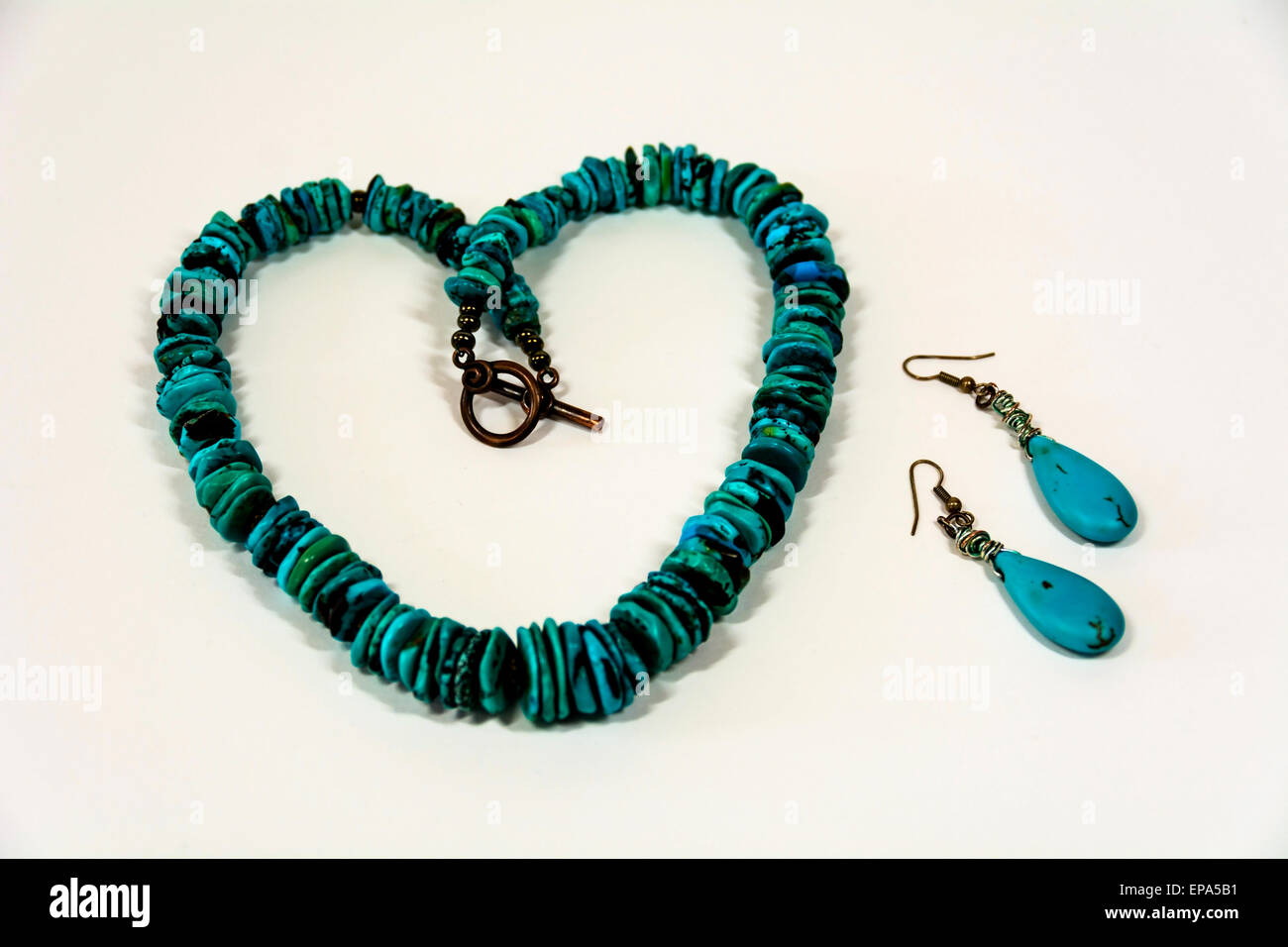 Flat round polished turquoise stones strung together to form a beautifully colourful necklace and turquoise drop earrings. Stock Photo