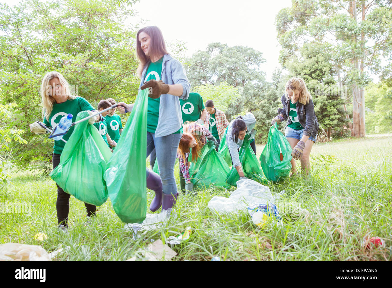 volunteering picking up trash field Stock Photo