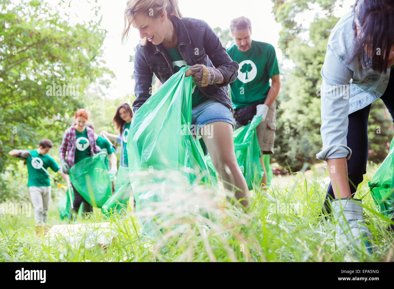 volunteering picking up trash field Stock Photo