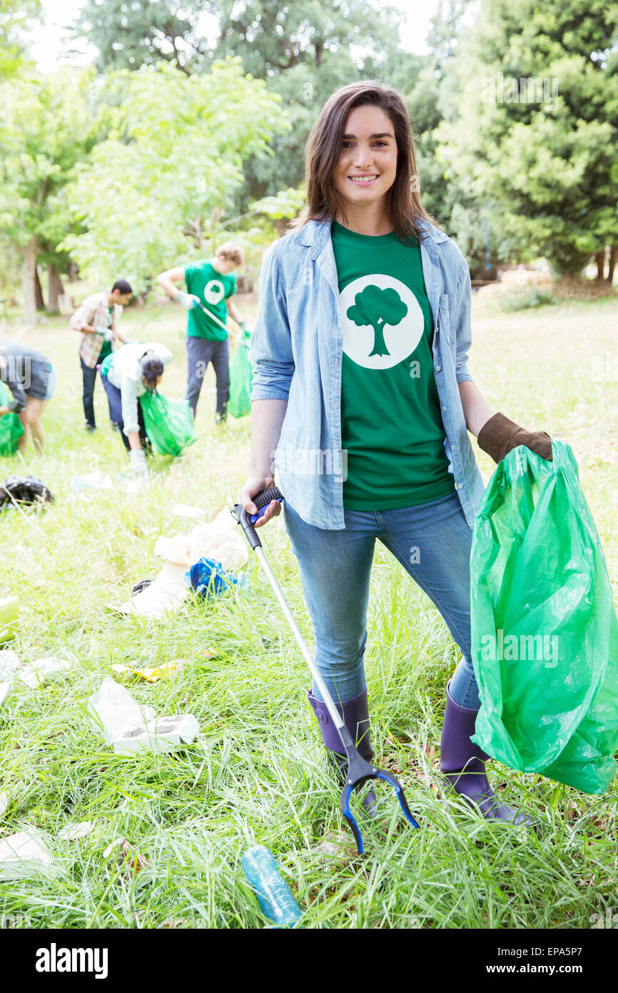 environmentalist volunteer picking up trash Stock Photo