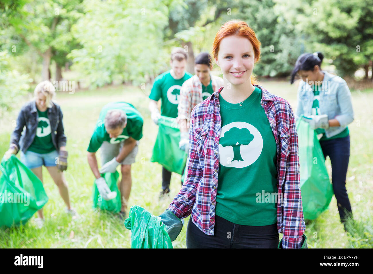 environmentalist volunteer picking up trash Stock Photo