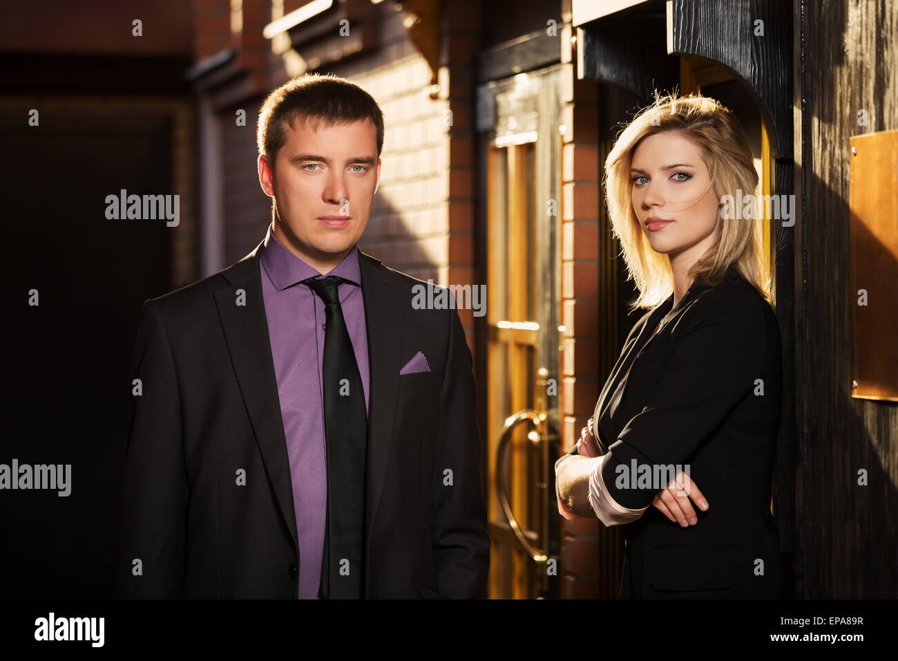 Young business couple against office building Stock Photo - Alamy