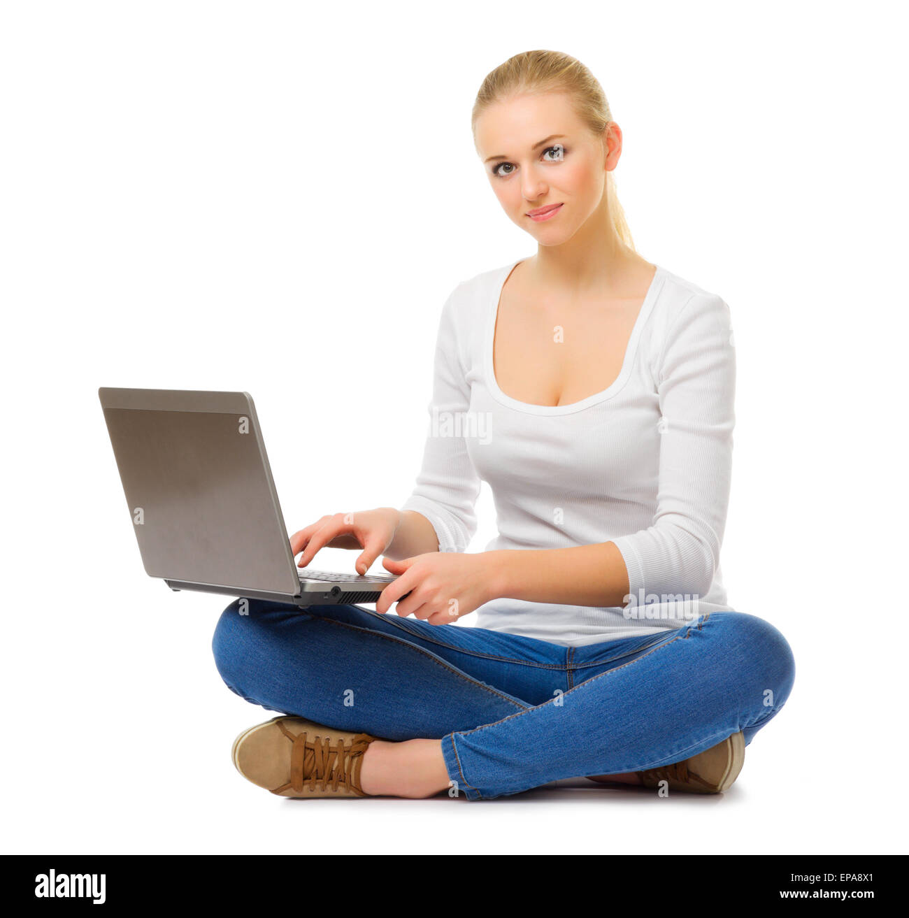 Young girl in jeans with laptop isolated Stock Photo - Alamy