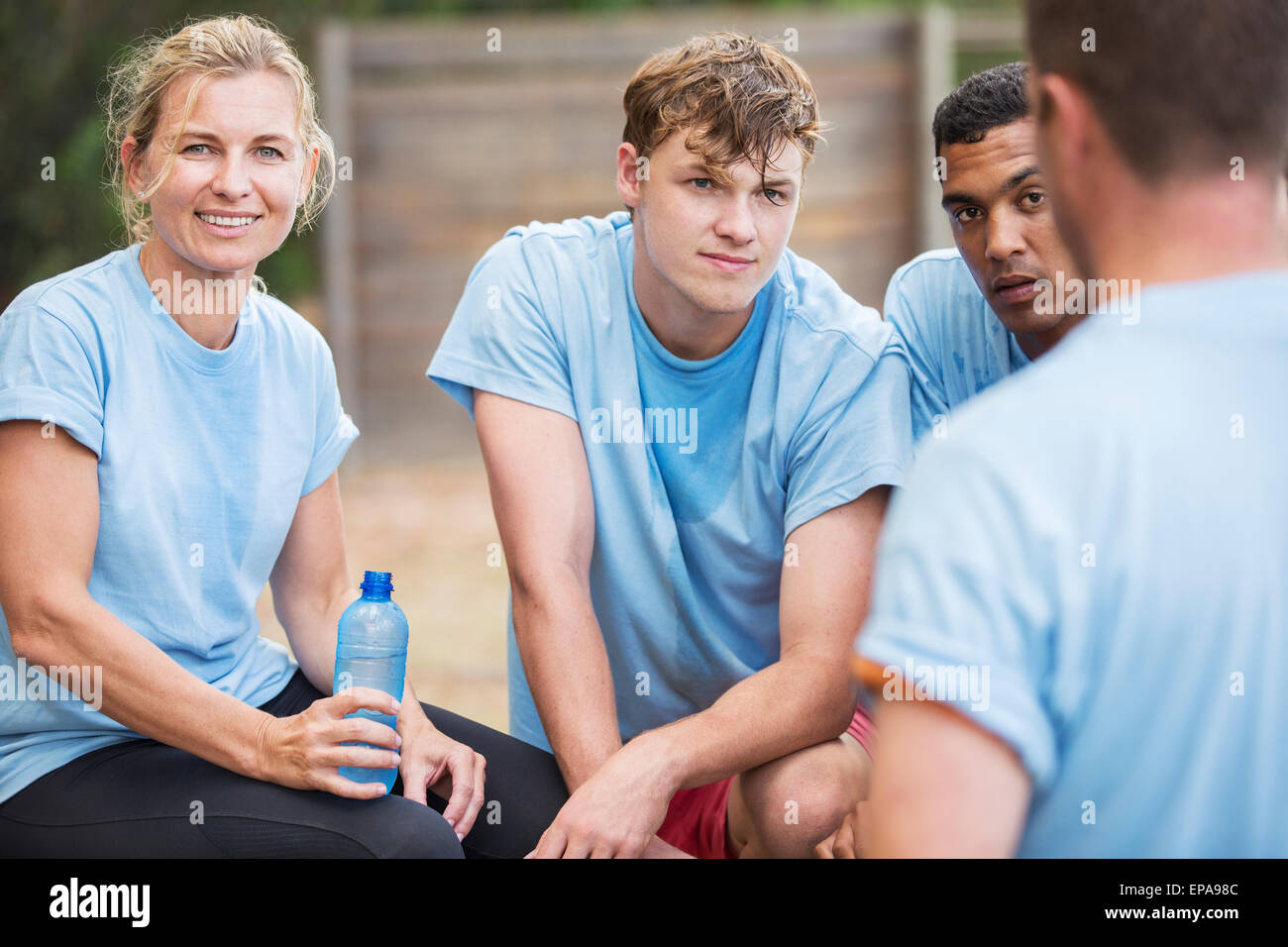 tired team resting drinking water boot camp Stock Photo Alamy