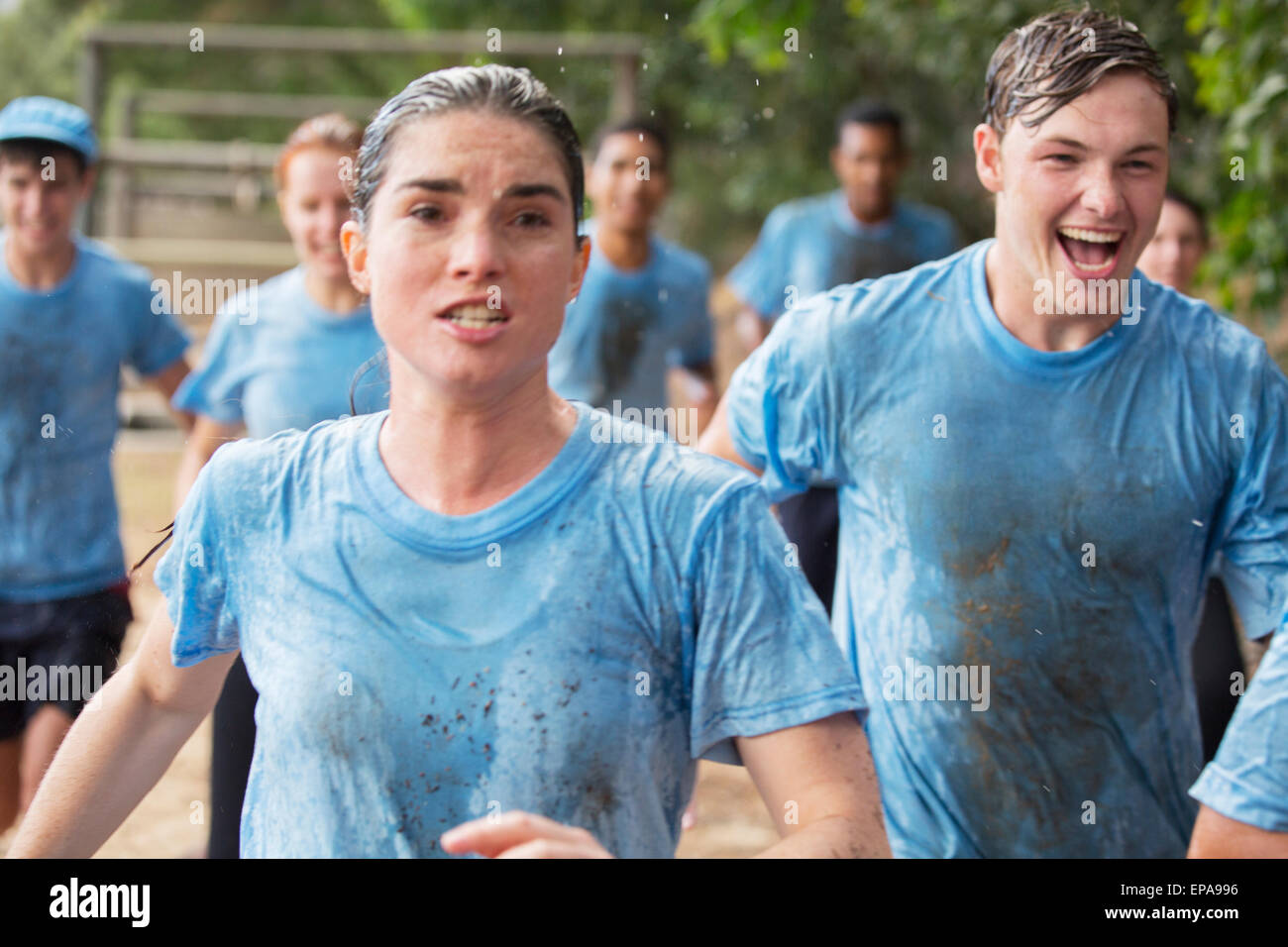 woman running boot camp obstacle course Stock Photo