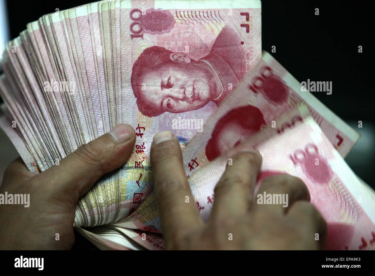 Counting Rmb A Chinese bank clerk counts RMB (renminbi) yuan banknotes at a bank in ...