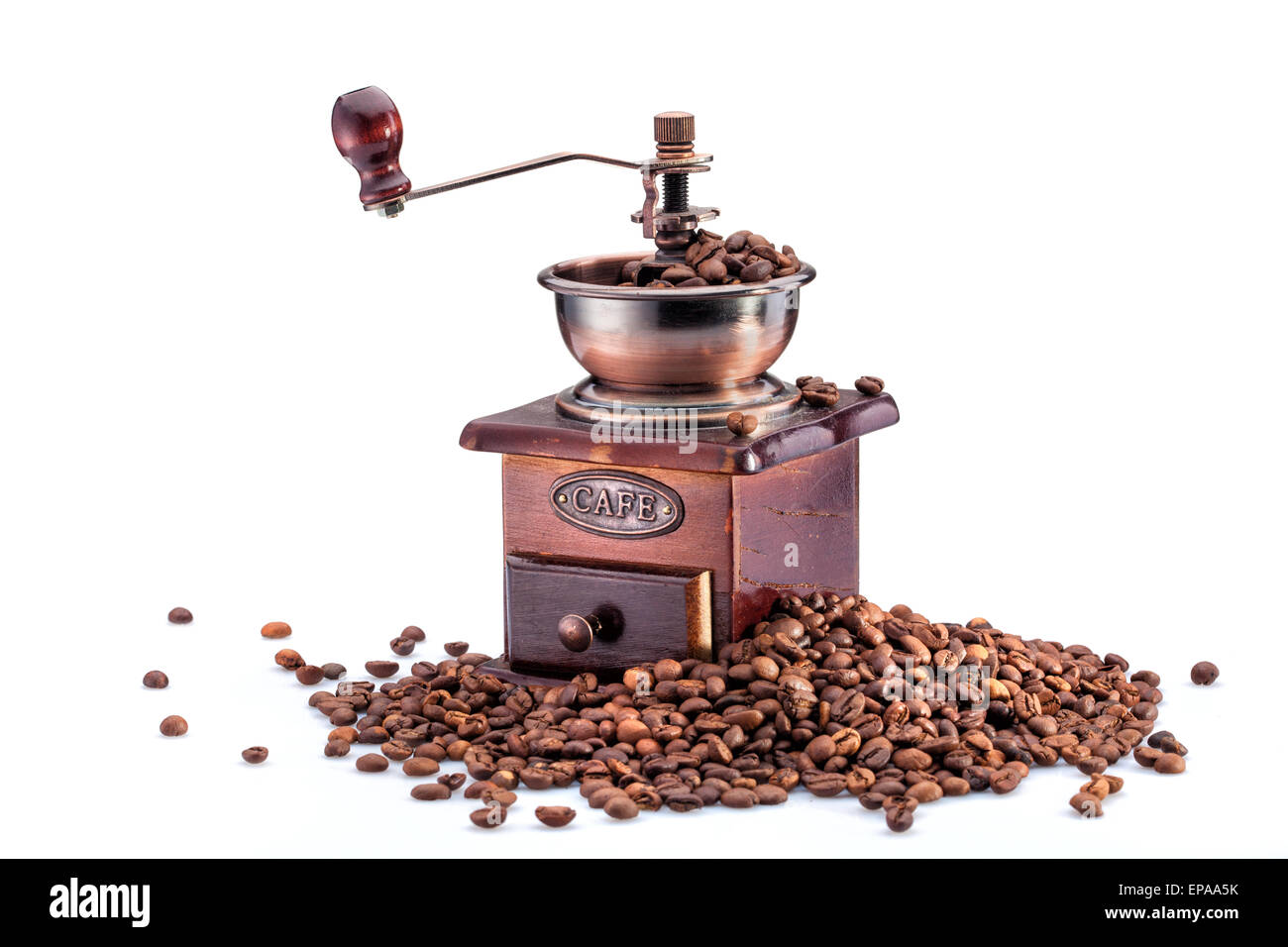 Retro manual coffee mill on roasted coffee beans isolated Stock Photo