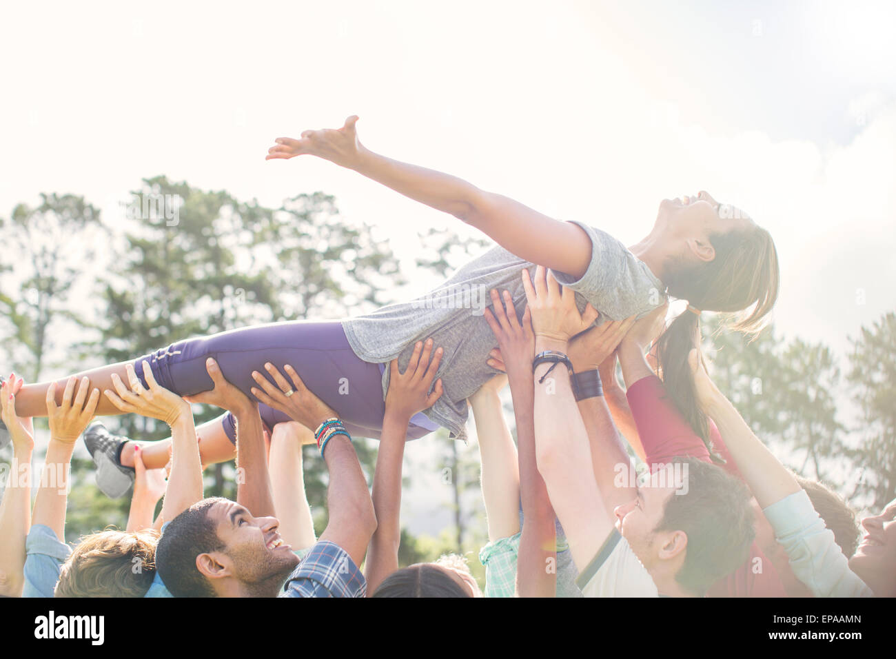 carefree woman crowdsurfing supporting team Stock Photo