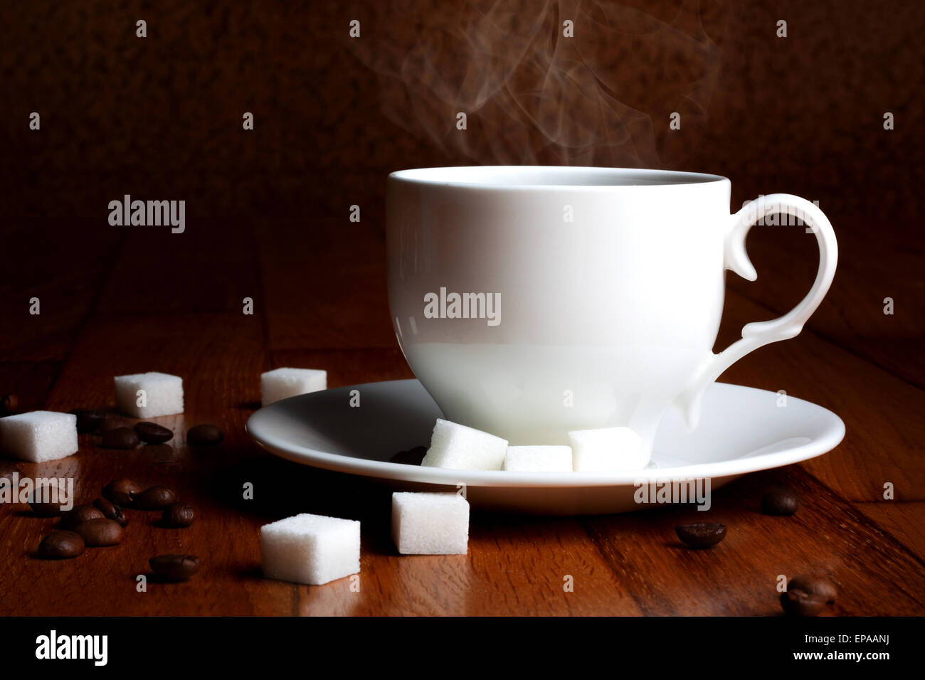 Fresh cup of hot coffee with sugar and natural grains on a wooden table Stock Photo