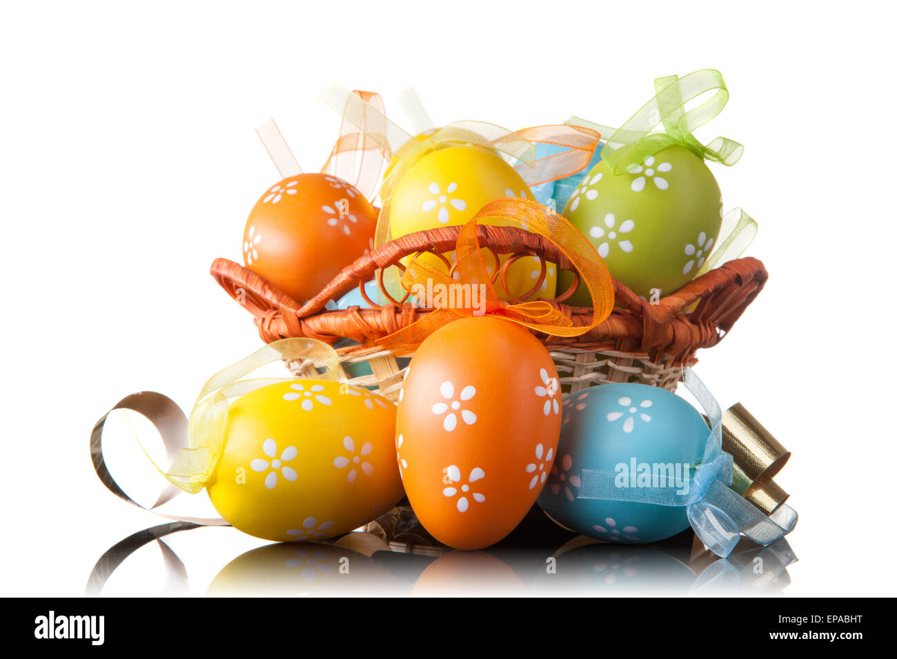 color easter eggs in basket isolated on white Stock Photo