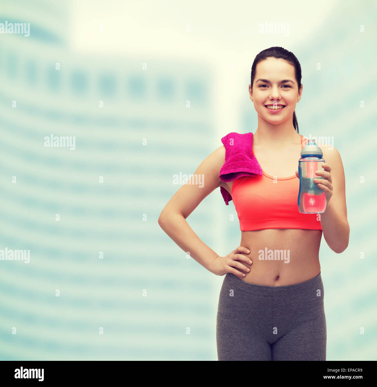 sporty woman with towel and water bottle Stock Photo - Alamy