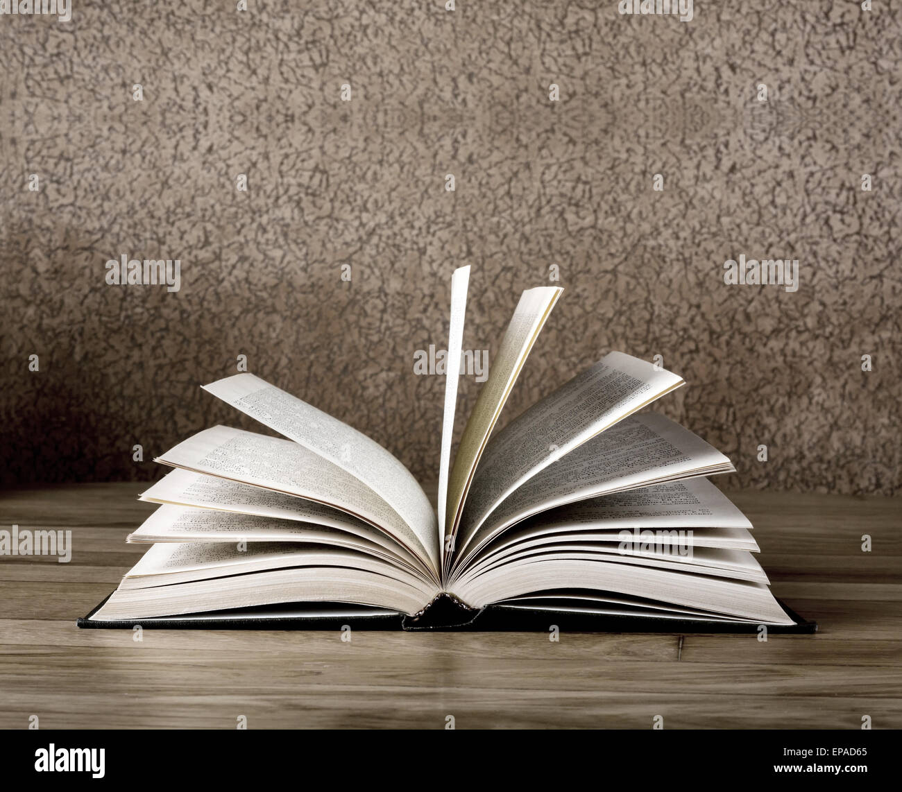 Old open book on grunge wooden table Stock Photo