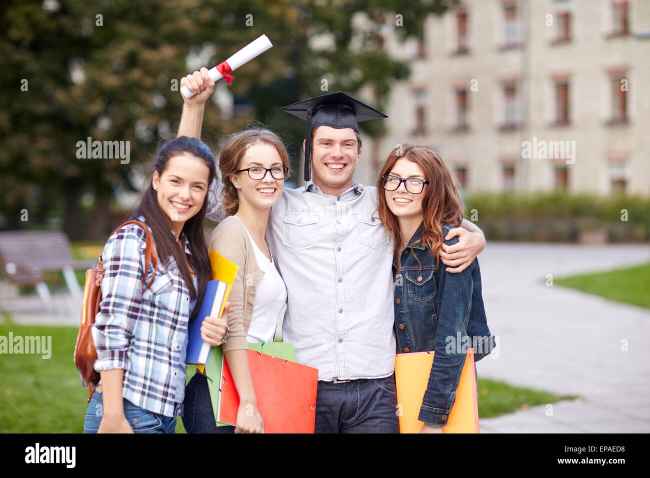 happy teenage students with diploma and folders Stock Photo - Alamy