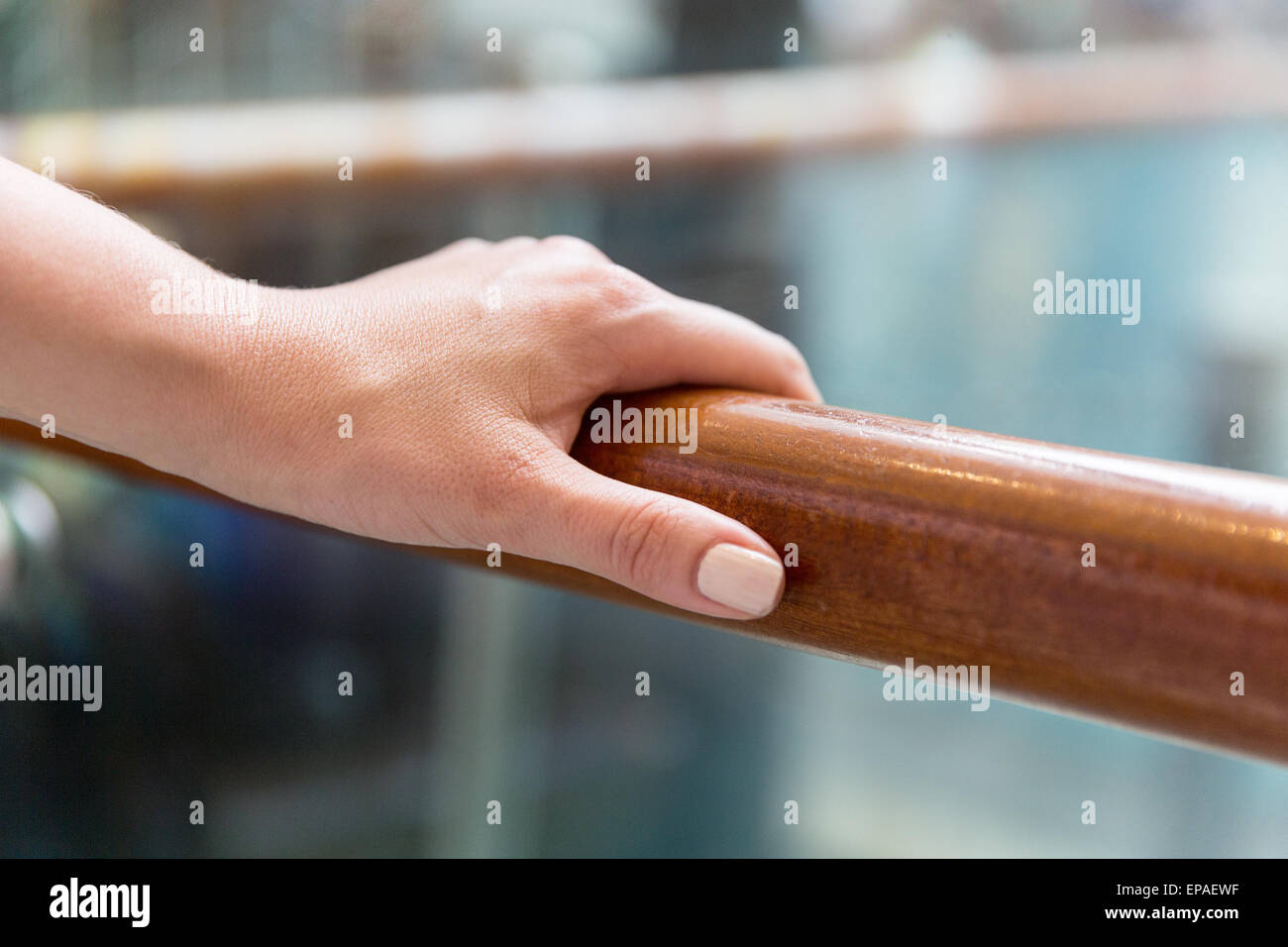 close up of woman hand holding to railing Stock Photo