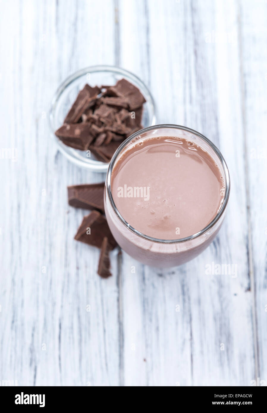 Cold Chocolate Milk drink (close-up shot) on wooden background Stock Photo