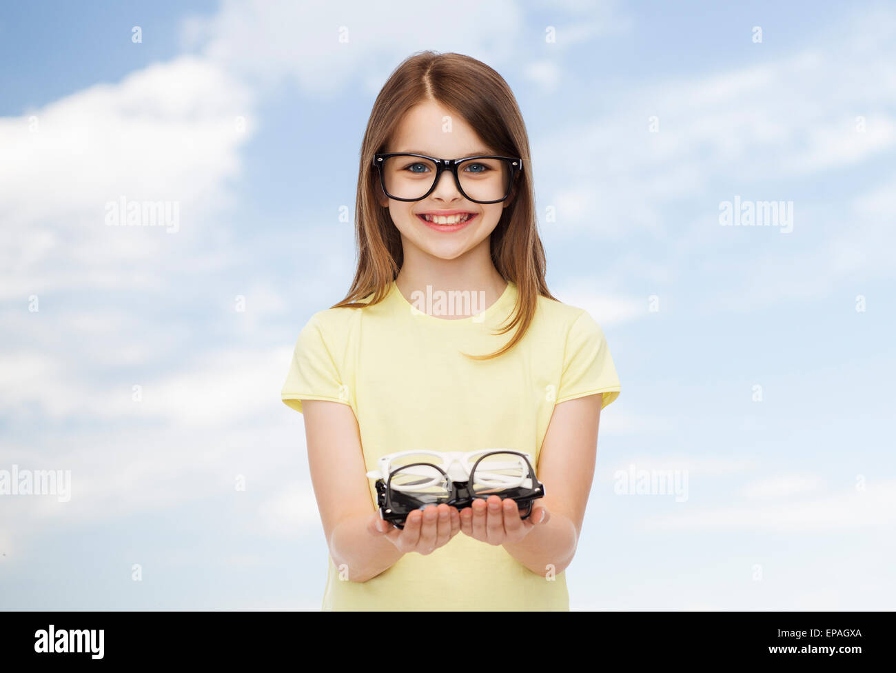 smiling cute little girl in black eyeglasses Stock Photo