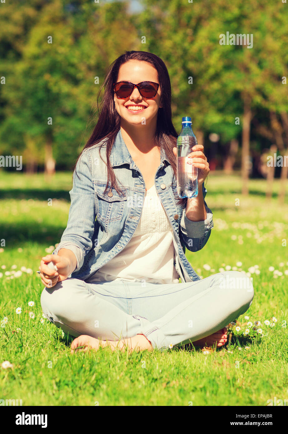 Teen girl drinking water from bottle in summer park. Drinking water in the  heat concept. Close-up Stock Video Footage by ©lizaelesina #489034632