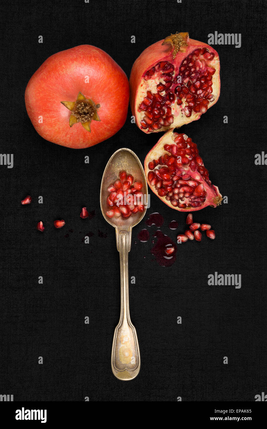 Fresh pomegranate background. Pomegranate core on black background, top view. Healthy fruit eating. Stock Photo