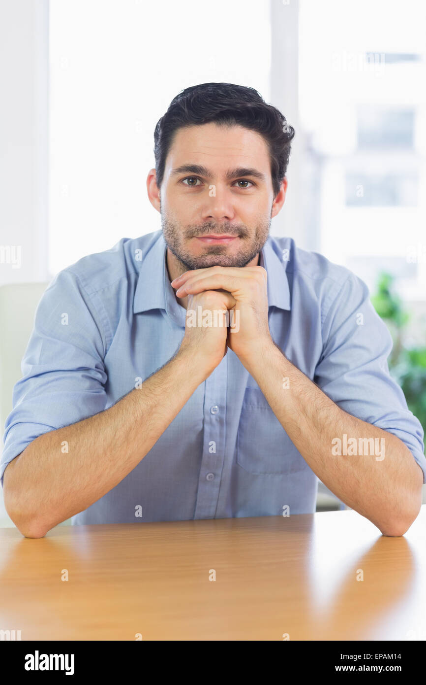 Businessman leaning on desk Stock Photo Alamy