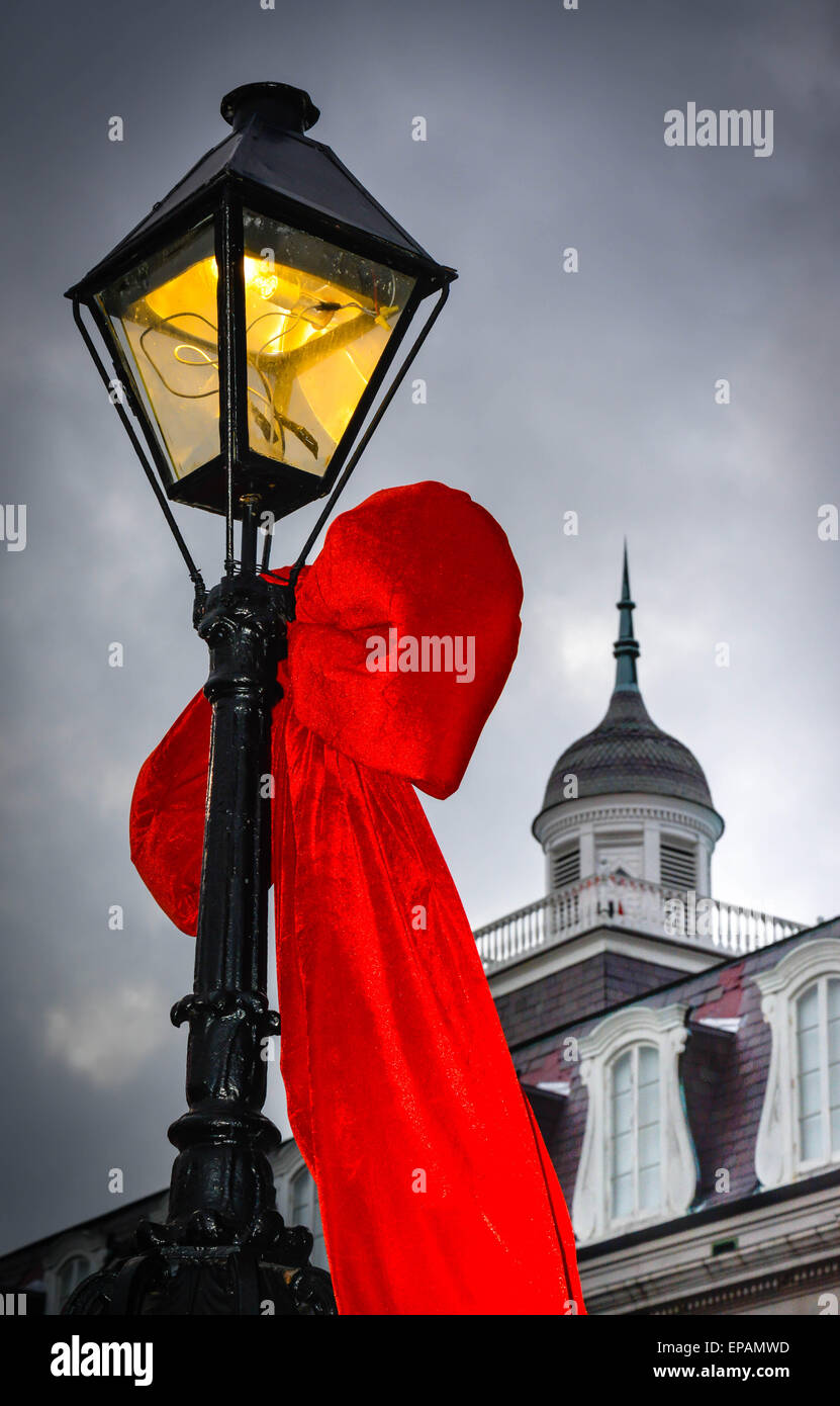 Big Red bows hang from the lamp posts near Louisiana State Museum, Jackson Square in French Quarter in New Orleans, LA Stock Photo
